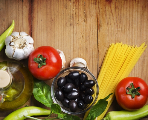 Food ingredients for italian pasta on a wooden table